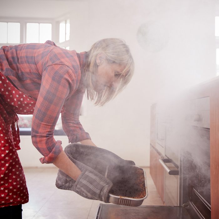 Middle aged woman opening smoke filled oven in the kitchen; Shutterstock ID 761804338; Job (TFH, TOH, RD, BNB, CWM, CM): TOH