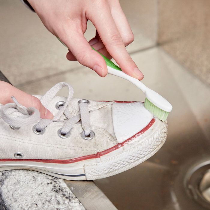 Cleaning shoe with toothbrush