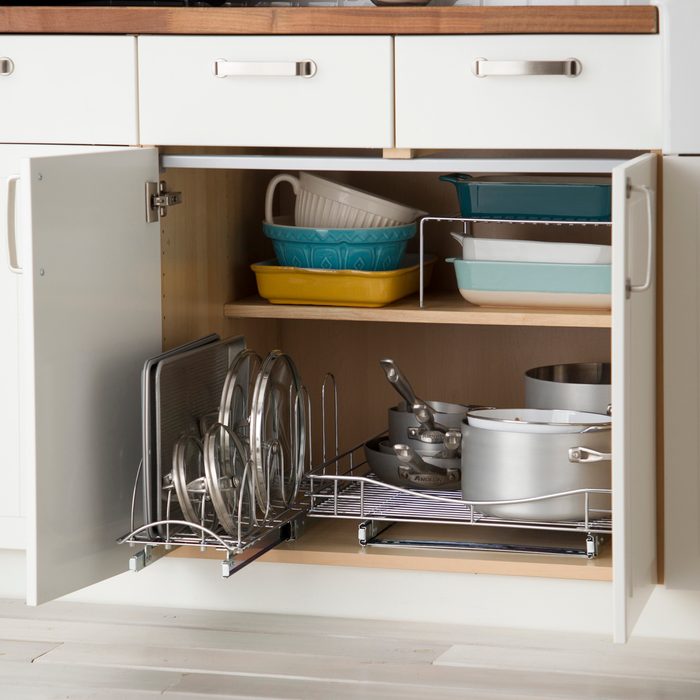 Sliding Pan And Lid Organizer inside a lower kitchen cabinet