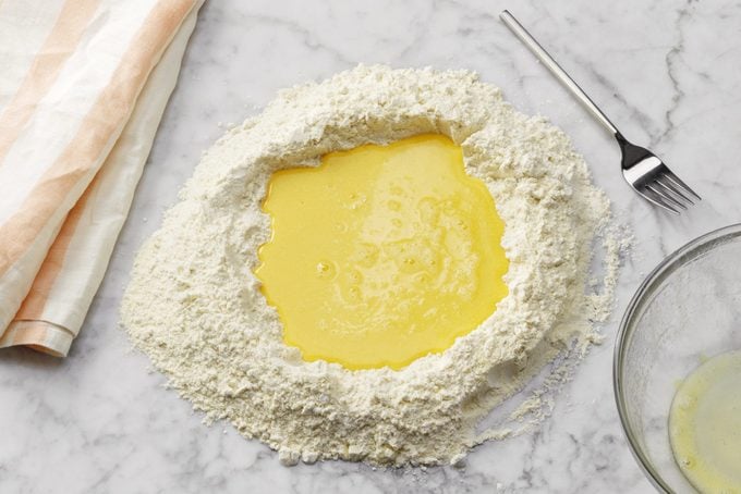 eggs in flour mound for homemade pasta