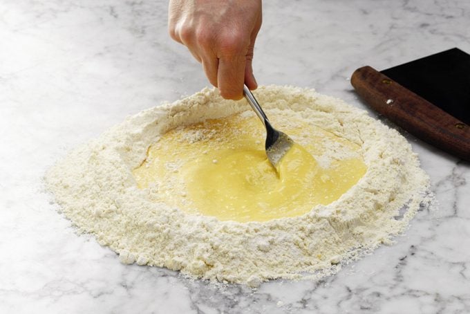 mixing eggs and flour for homemade pasta