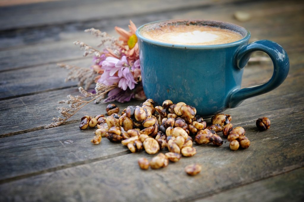 Black honey process coffee, Hot latte on an old wooden background, vintage stye.