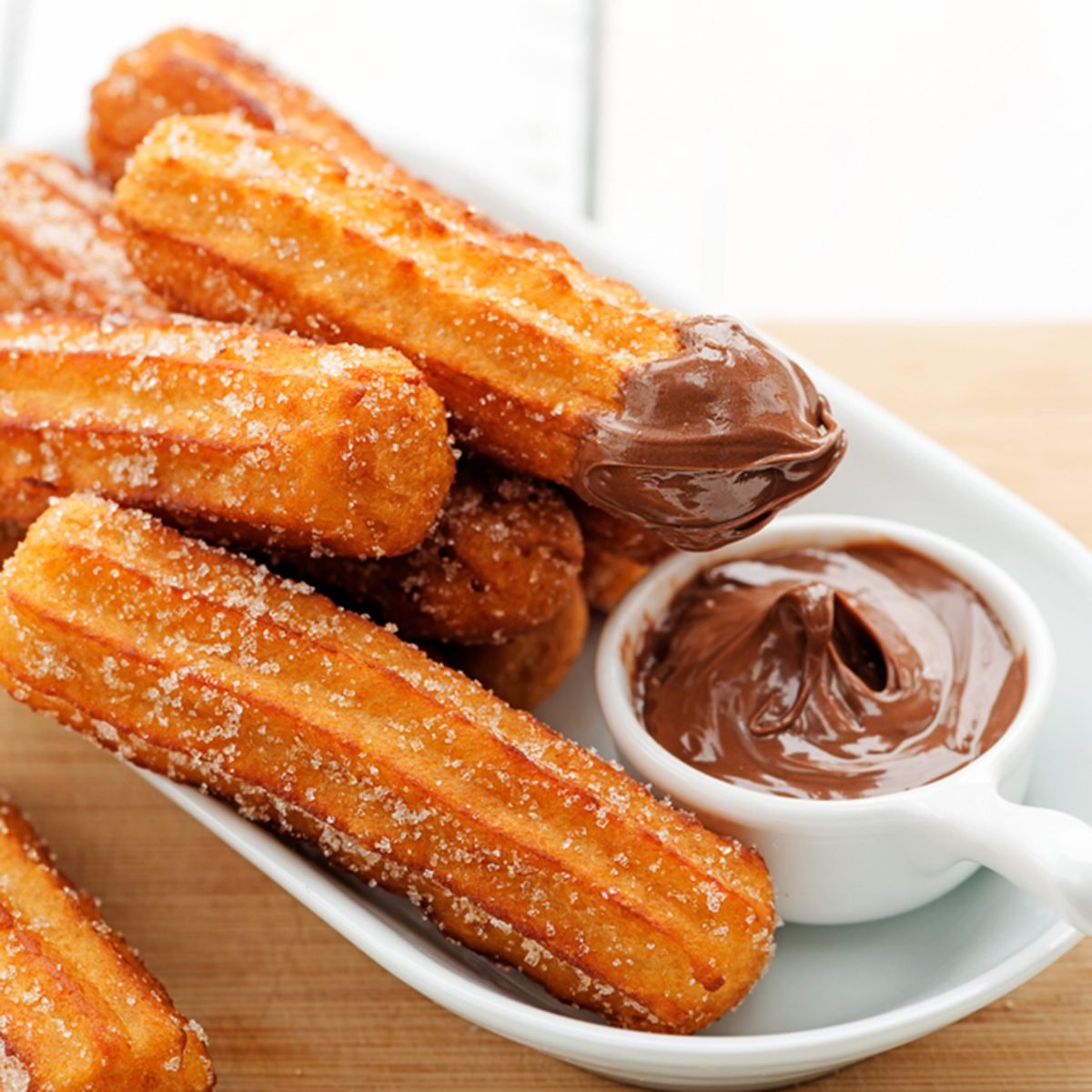 Churros with sugar and chocolate sauce . top view ; Shutterstock ID 1035673351; Job (TFH, TOH, RD, BNB, CWM, CM): TOH
