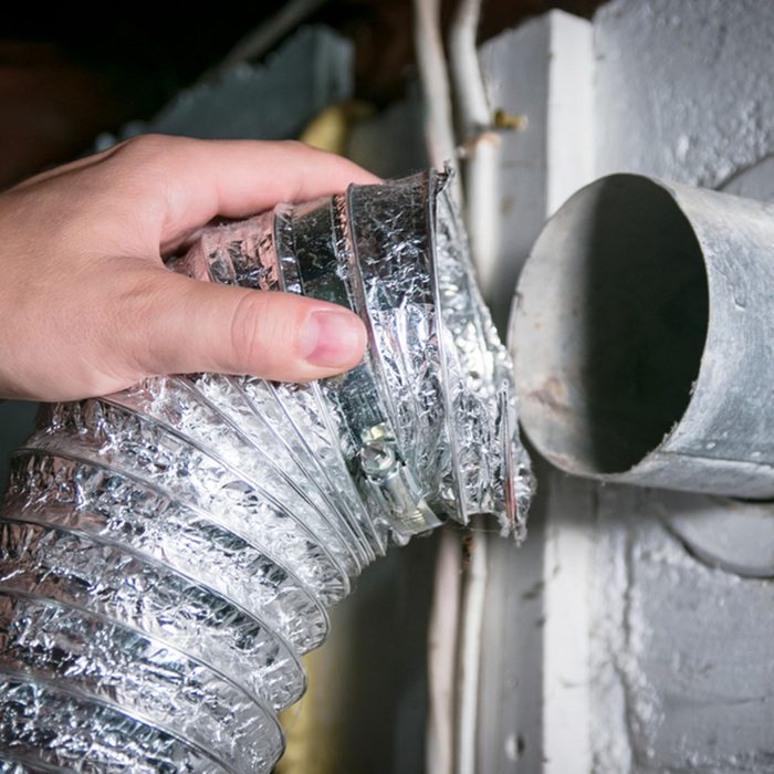 Flexible aluminum dryer vent hose, removed for cleaning/repair/maintenance. ; Shutterstock ID 1156231702