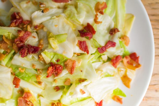 Asia food, Stir fried cabbage with fish sauce and crispy bacon on wooden table