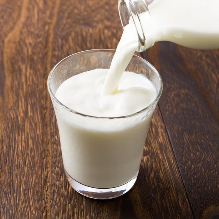 Pouring milk into glass; Shutterstock ID 279701309