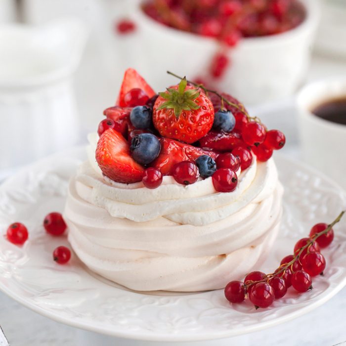 Pavlova meringue cake with fresh berries on white background; Shutterstock ID 351659969; Job (TFH, TOH, RD, BNB, CWM, CM): TOH