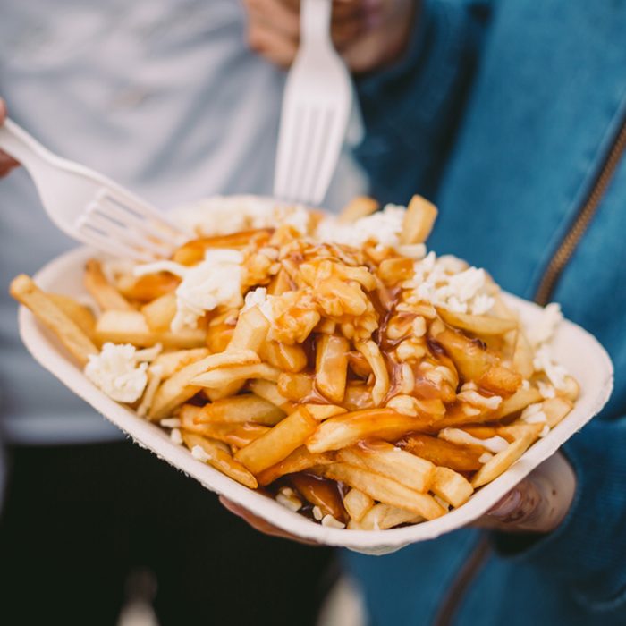 Poutine being eaten with forks; Shutterstock ID 797302909; Job (TFH, TOH, RD, BNB, CWM, CM): TOH
