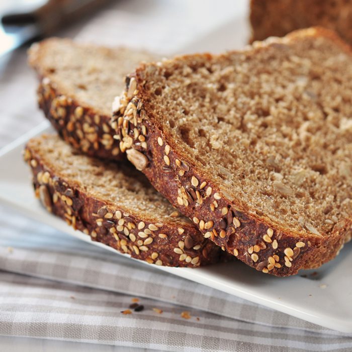 Sliced bread with sunflower seeds and sesame on a plate