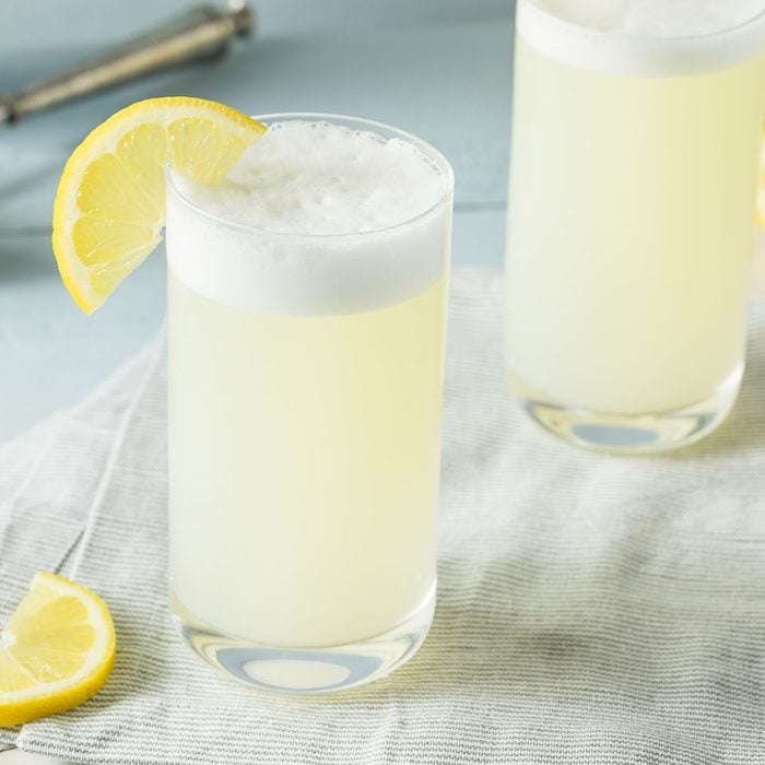Refreshing Cold Egg Gin Fizz with a Lemon Garnish