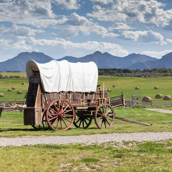 covered wagon against a mountain landscape oregon trail