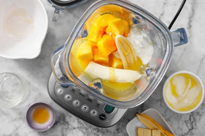 Mango Smoothies Showing all ingredients combined in a blender not yet blended