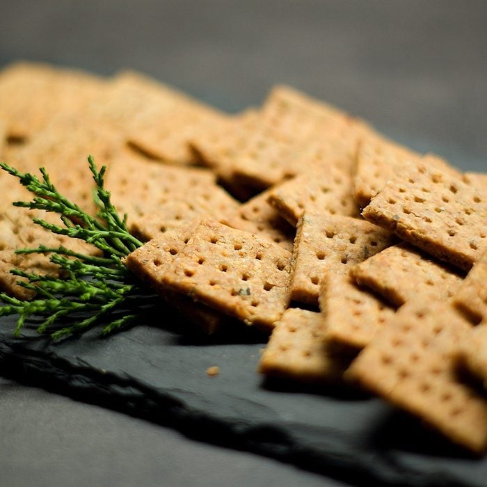 Homemade cheese whole grain squared crackers on slate tray