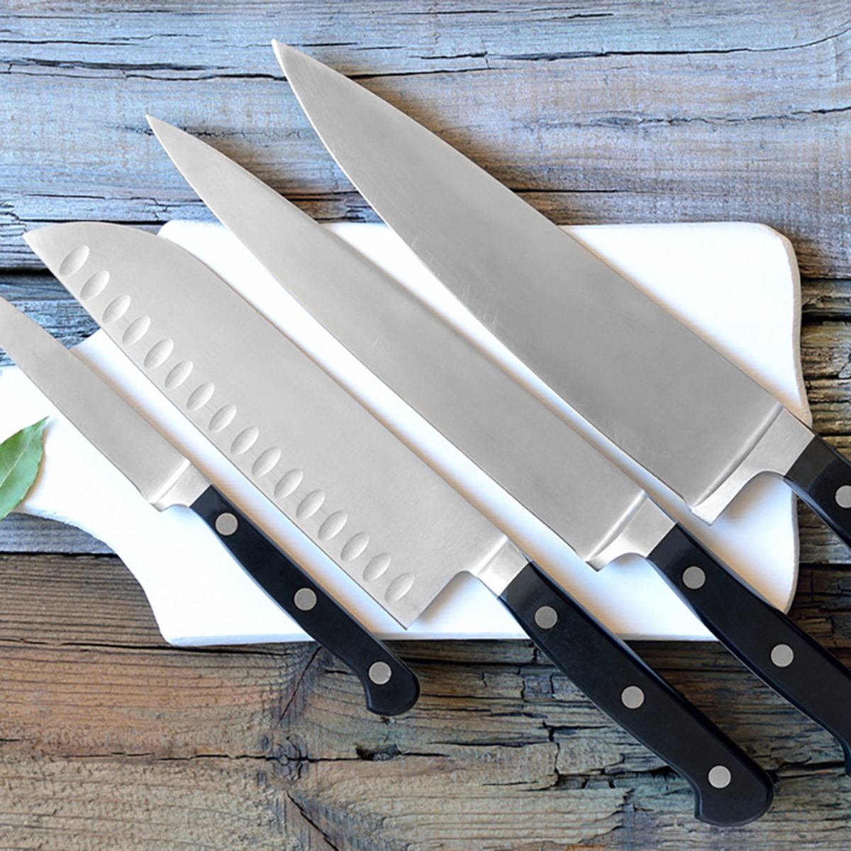 Set of kitchen knives on a board