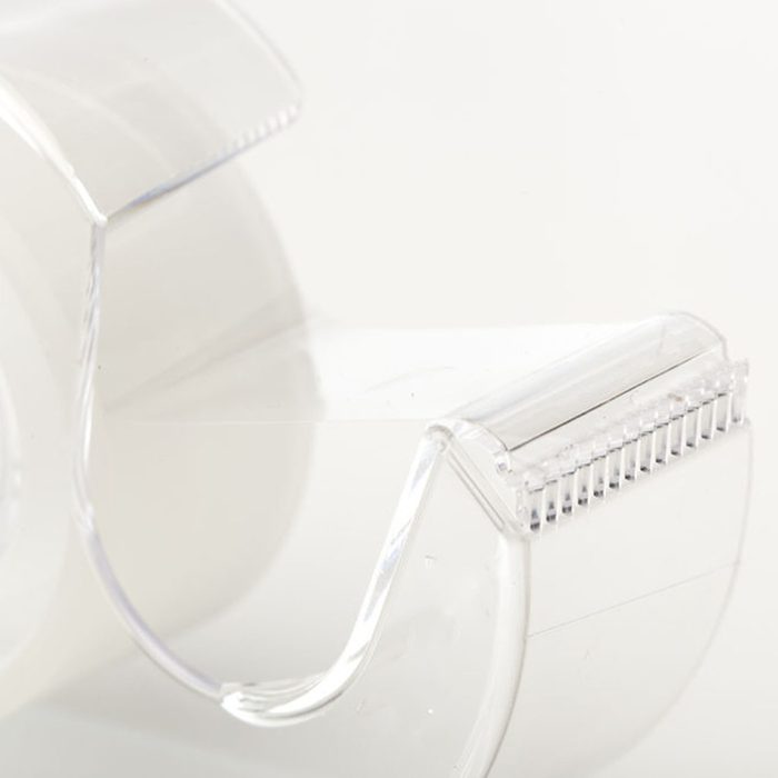 A Clear tape dispenser against a white background