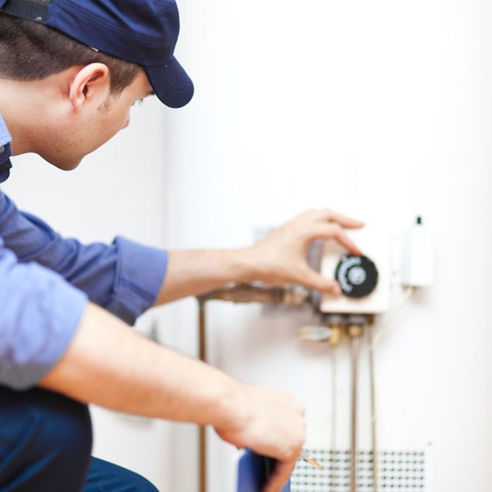 Plumber repairing an hot-water heater; Shutterstock ID 142322101; Job (TFH, TOH, RD, BNB, CWM, CM): Taste of Home