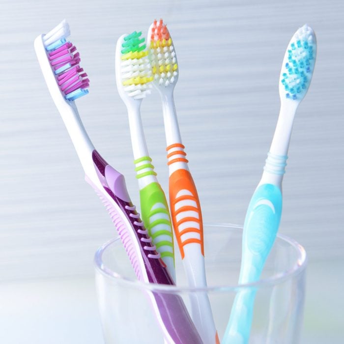 Toothbrushes in glass on table on light background; Shutterstock ID 194646521; Job (TFH, TOH, RD, BNB, CWM, CM): Taste of Home