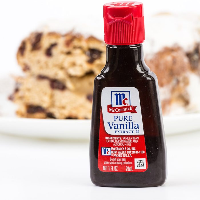 LLANO, TEXAS-DEC 24, 2014: Small bottle of McCormick Pure Vanilla Extract with baked cake in background. Horizontal with copy space.; Shutterstock ID 239758756