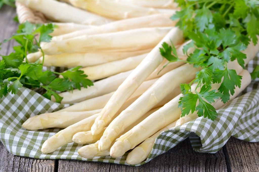 Fresh white asparagus of Germany - Bavaria on a wooden table