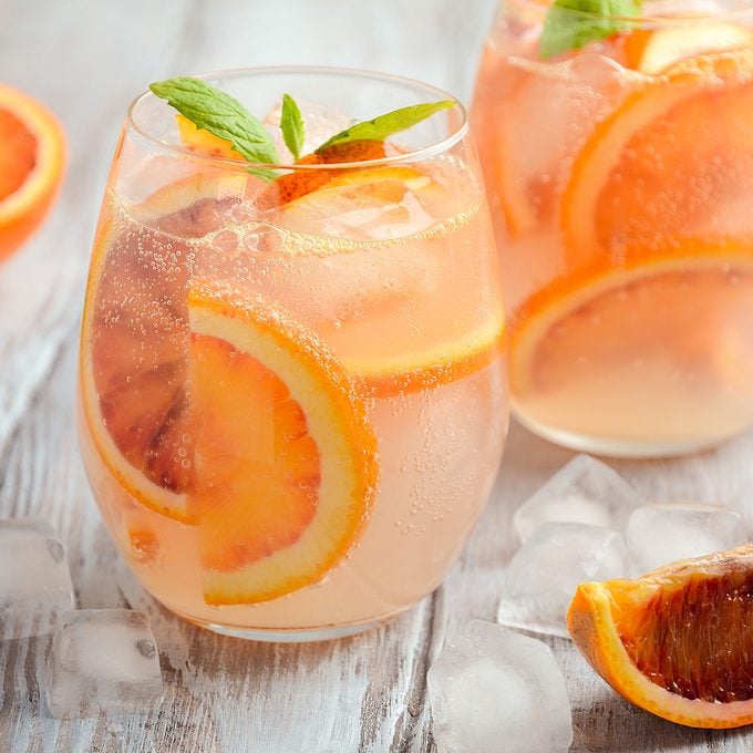Cold refreshing drink with blood orange slices in a glass on a wooden background. Selective focus.; Shutterstock ID 608945540; Job (TFH, TOH, RD, BNB, CWM, CM): Taste of Home
