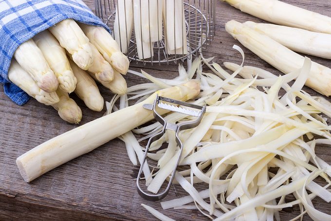 White asparagus is peeled with a knife ; Shutterstock ID 651948631; Job (TFH, TOH, RD, BNB, CWM, CM): Taste of Home