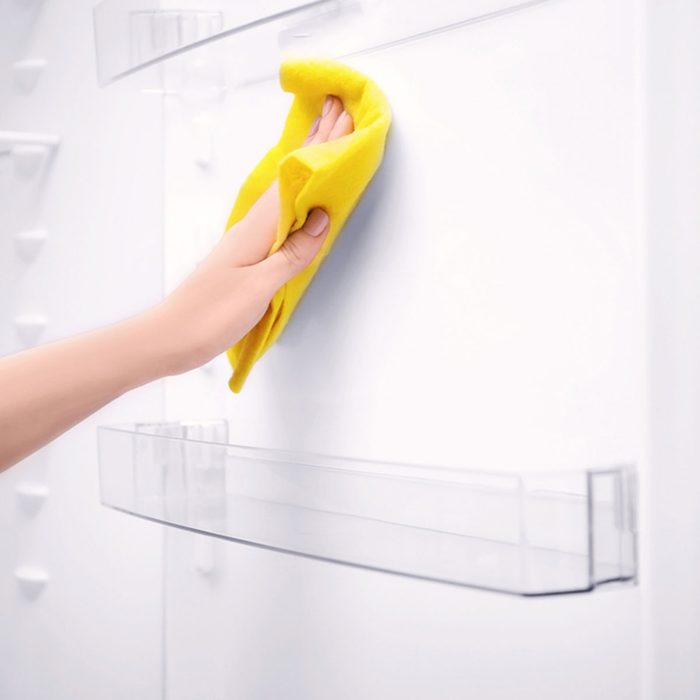 Woman cleaning refrigerator with rag, closeup; Shutterstock ID 787859368; Job (TFH, TOH, RD, BNB, CWM, CM): Taste of Home