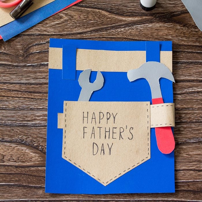 Greeting card with Happy fathers day on wooden table