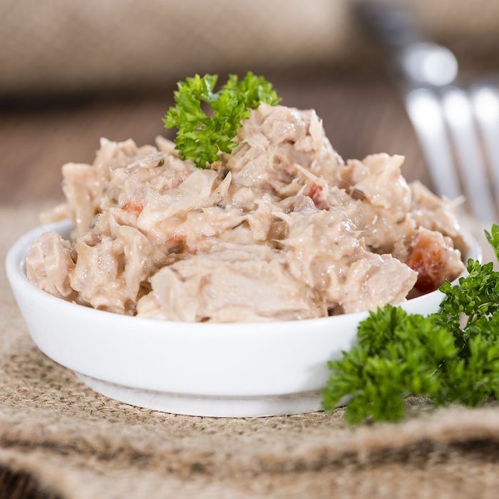 Homemade Tuna Salad in a small bowl (on wooden background)