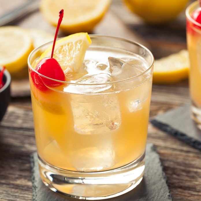 Homemade Whiskey Sour Cocktail Drink with a Cherry Lemon