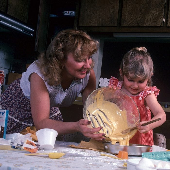Mandatory Credit: Photo by Ralph Hampton/REX/Shutterstock (348408b) Model Released - Child cooking helped by her mother Child Cooking - 1981