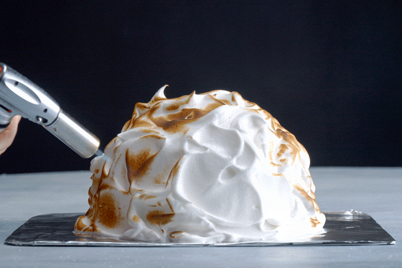gif of hand using kitchen torch to toast the meringue