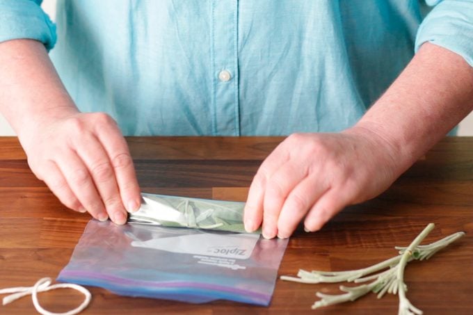 Storing herbs in airtight ziplock by pressing extra air out