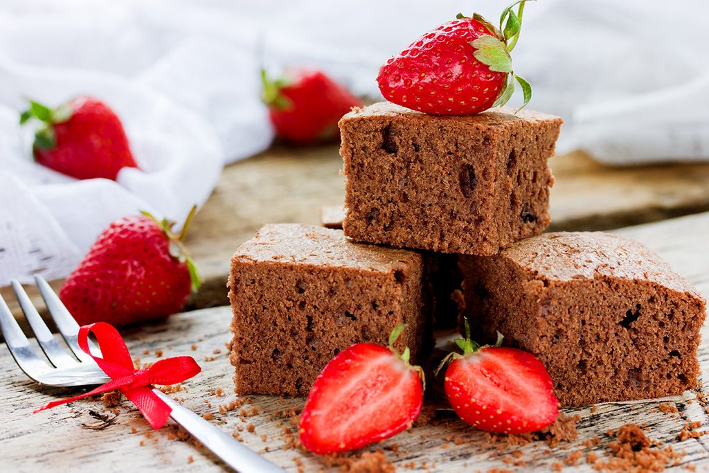 Chocolate cake with strawberry, traditional American cuisine, dark brownie with chocolate selective focus