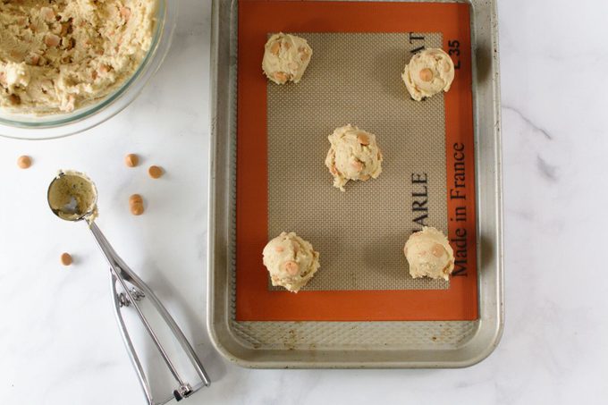 Cookie dough drops on a baking sheet