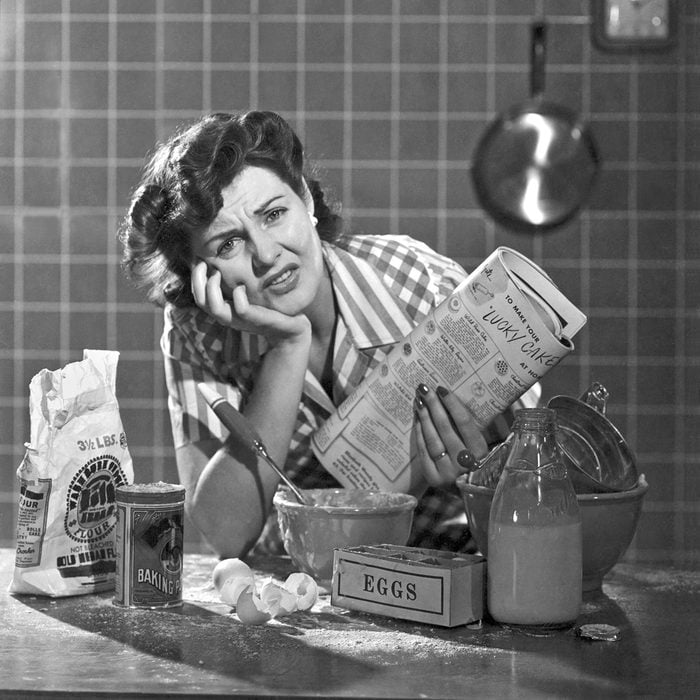 A frustrated woman with a mess in her kitchen from trying to bake a cake. It was an early ad for Bisquick.