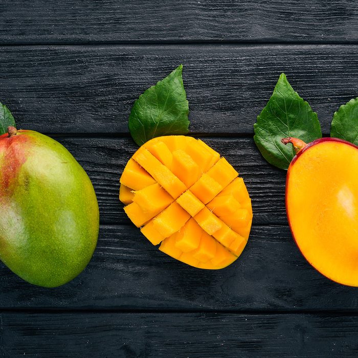 Mango. Tropical Fruits. On a wooden background.
