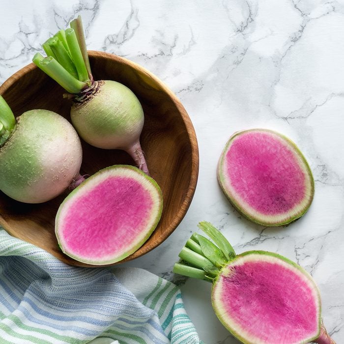 Watermelon red radish (chinese daikon) on marble table.