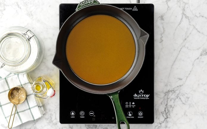 Caramel Roux in a saucepan on a hot plate on a marble countertop
