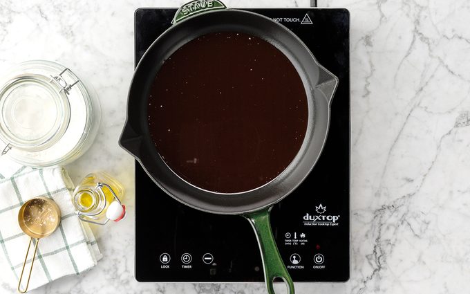 Roux Dark in a sauce pan on a hot plate on a marble kitchen counter