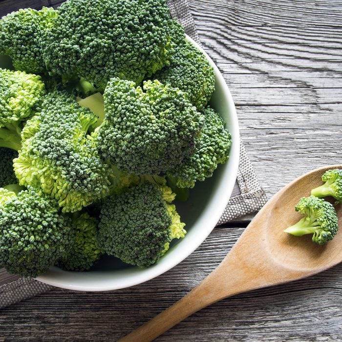 high fiber foods: Raw broccoli on wooden background