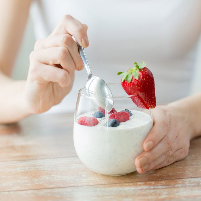 healthy eating, vegetarian food, diet and people concept - close up of woman hands with yogurt and berries on table; Shutterstock ID 286560938; Job (TFH, TOH, RD, BNB, CWM, CM): Taste of Home