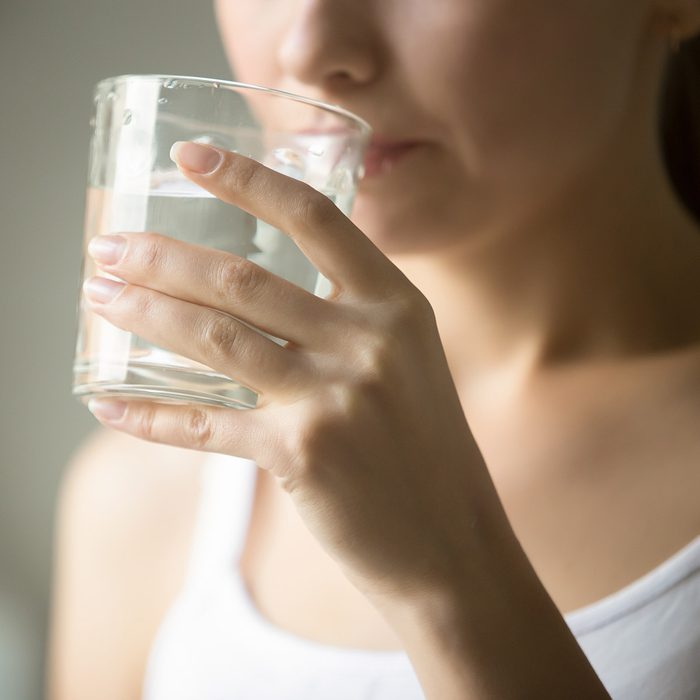 Female drinking from a glass of water. Health care concept photo, lifestyle, close up; Shutterstock ID 511513108
