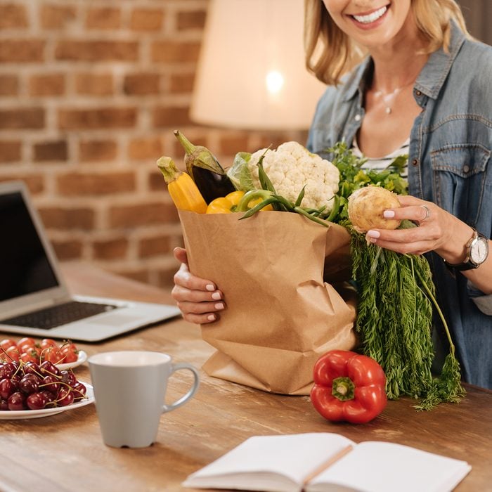 Charming neat woman examining contents of the bag; Shutterstock ID 687220006; Job (TFH, TOH, RD, BNB, CWM, CM): TOH