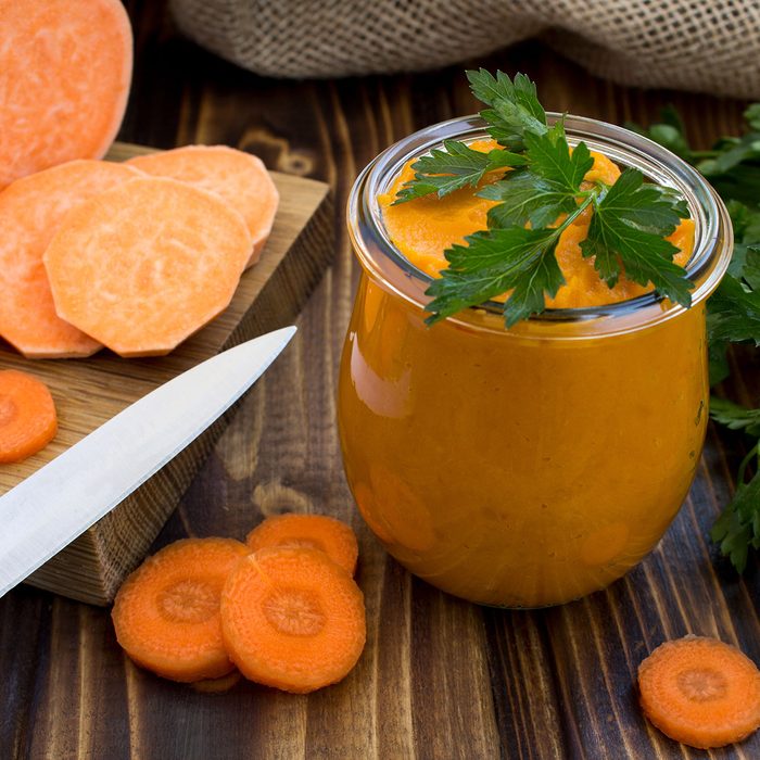 Vegetarian puree with sweet potato,carrot and ingredients on the wooden background