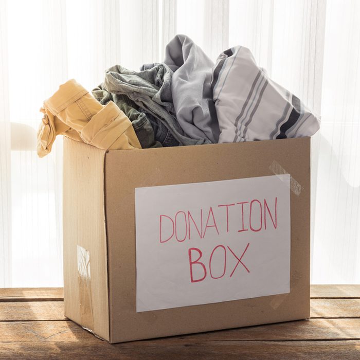 Clothing donation box on wooden background