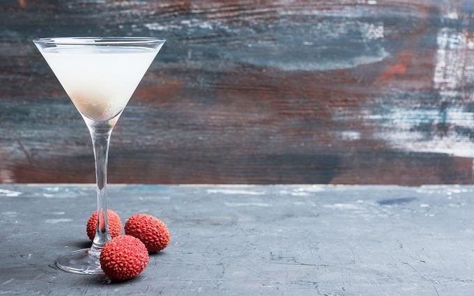Sweet lychee martini on the rustic background.