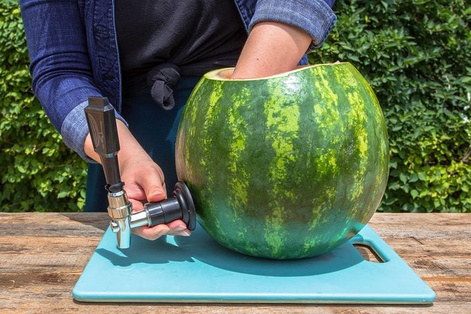 putting a tap onto the outside of the watermelon
