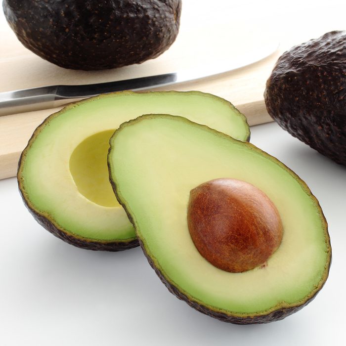 Cut fresh avocado on cutting board/ Avocado; Shutterstock ID 663927946; Job (TFH, TOH, RD, BNB, CWM, CM): TOH