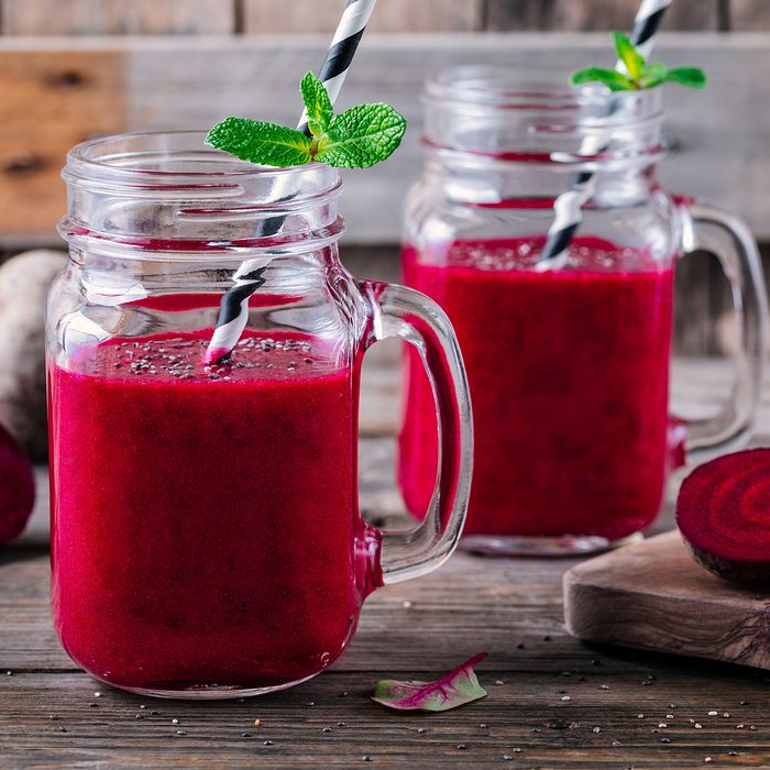 healthy detox beet smoothie with chia seeds in a mason jar on a wooden background