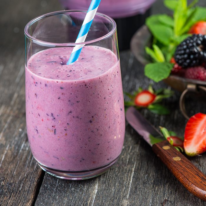 Homemade antioxidant summer fruits smoothie on rustic table